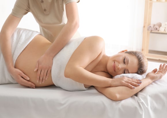 Woman receiving a prenatal massage at home