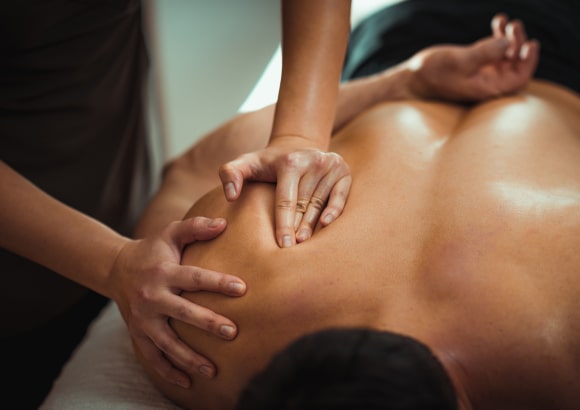 Man receiving a sports massage at home in Los Angeles