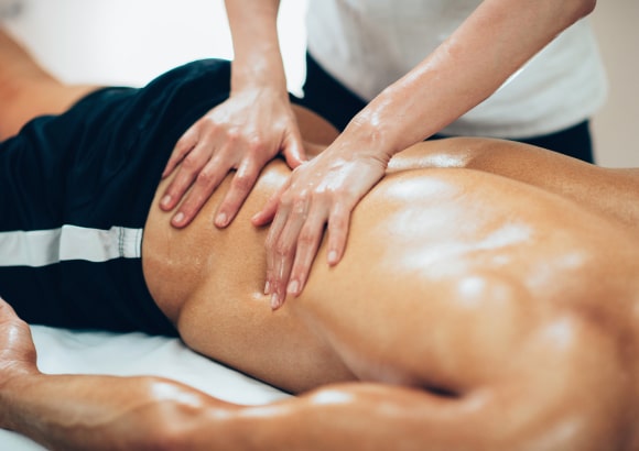 Man receiving am in-room sports massage