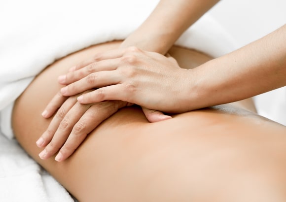Woman enjoying an in-room Swedish massage