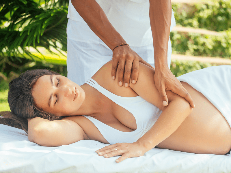 A woman getting a prenatal massage from Tranquil, a mobile massage company in Las Vegas and Los Angeles, after doing a prenatal massage near me search